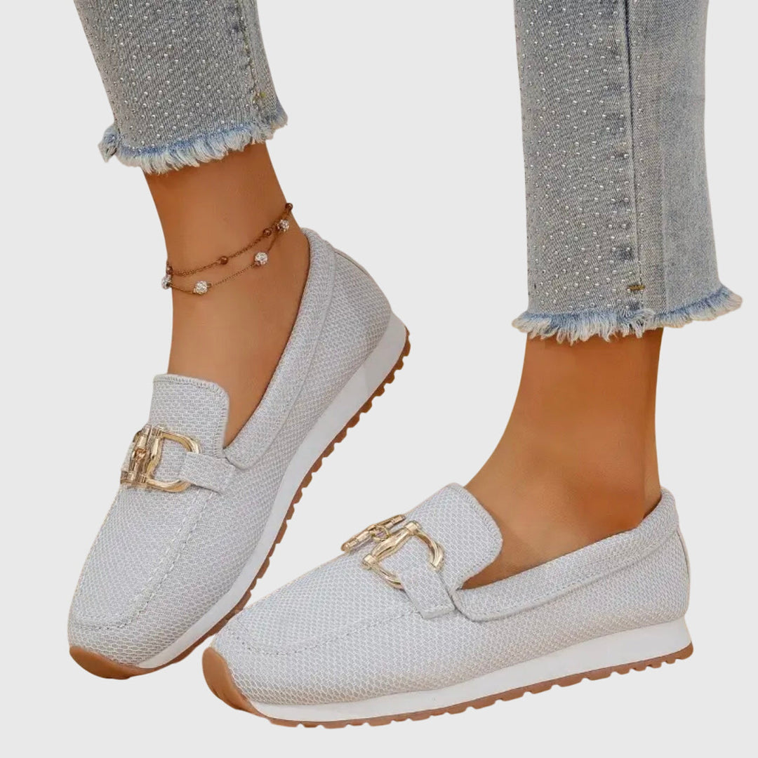 White women's orthopedic slip-on loafers, providing arch support and comfort for daily walks.