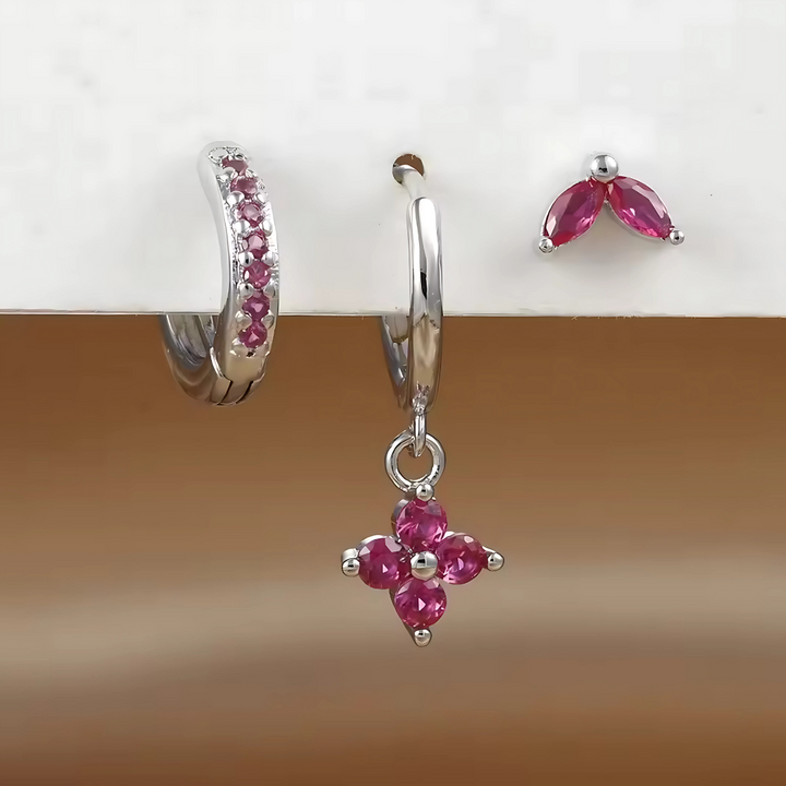 Fashionable women's stackable earring set: multiple surgical steel hoops & studs for versatile ear piercings.