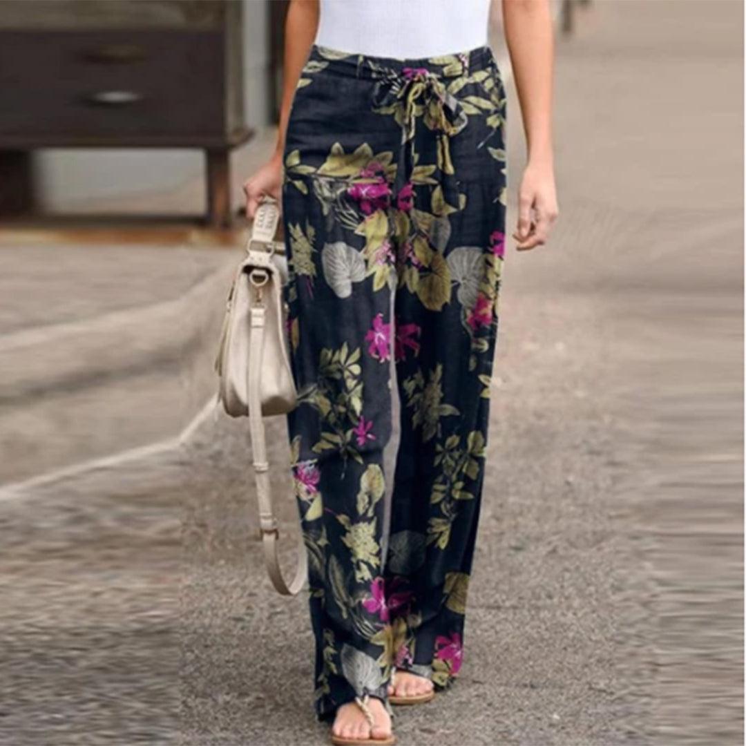 Vibrant women's floral printed trousers with a stylish bow, ideal for spring & summer fashion.