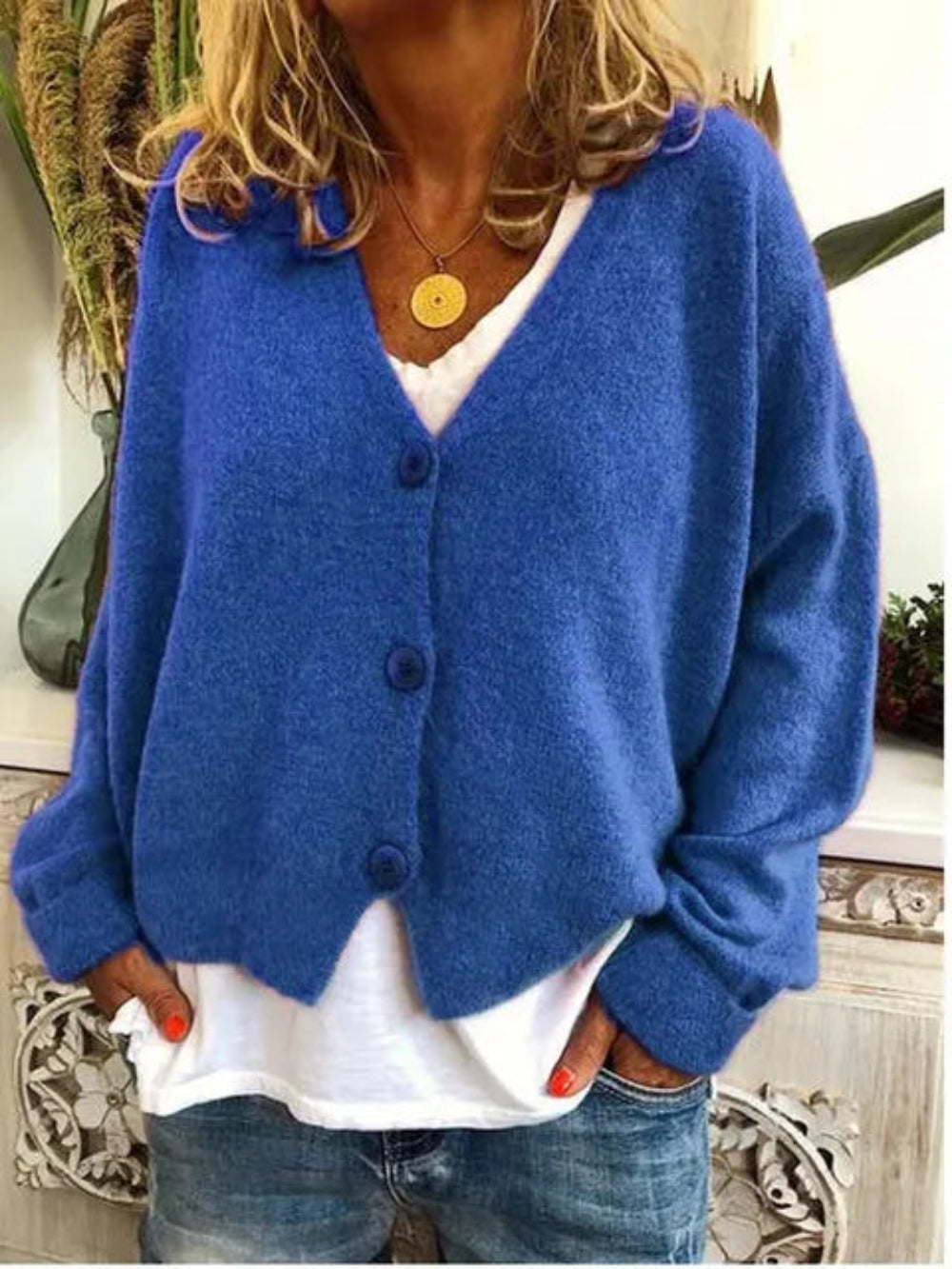 Close-up of a women's knit V-neck cardigan showing button-front detail & soft texture, great for stylish layering.