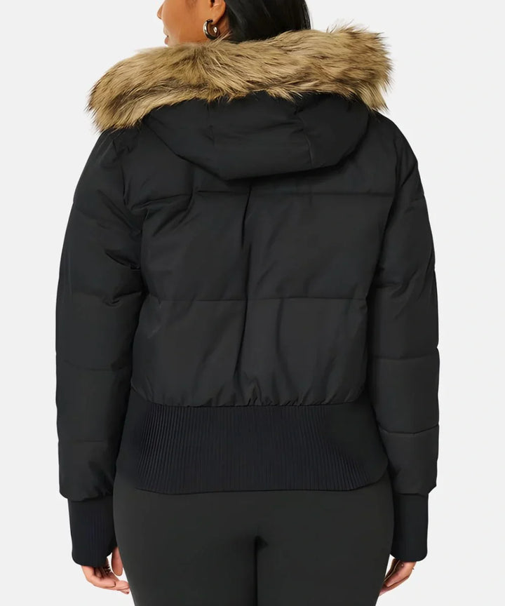 Elegant women's winter jacket with a luxurious faux fur hood and quilted pattern.