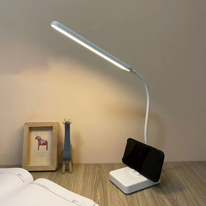 Sleek adjustable LED desk lamp, dimmable & flexible, providing focused light for any task or reading.