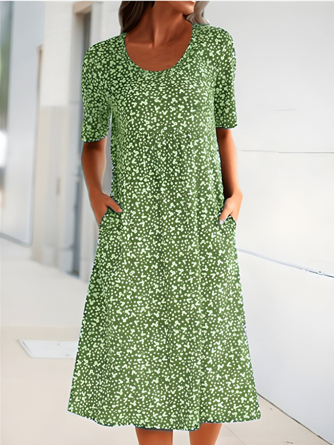 Relaxed fit women's floral summer dress with a round neck & practical pockets. Comfortable & stylish casual midi dress.