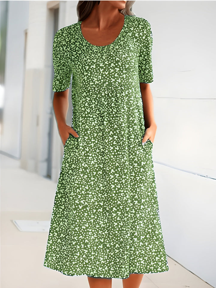 Relaxed fit women's floral summer dress with a round neck & practical pockets. Comfortable & stylish casual midi dress.