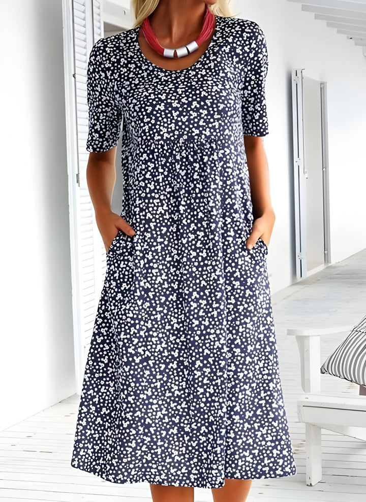 Elegant women's casual floral dress with a round neck and pockets. Ideal for vacation wear, summer, and everyday comfort.