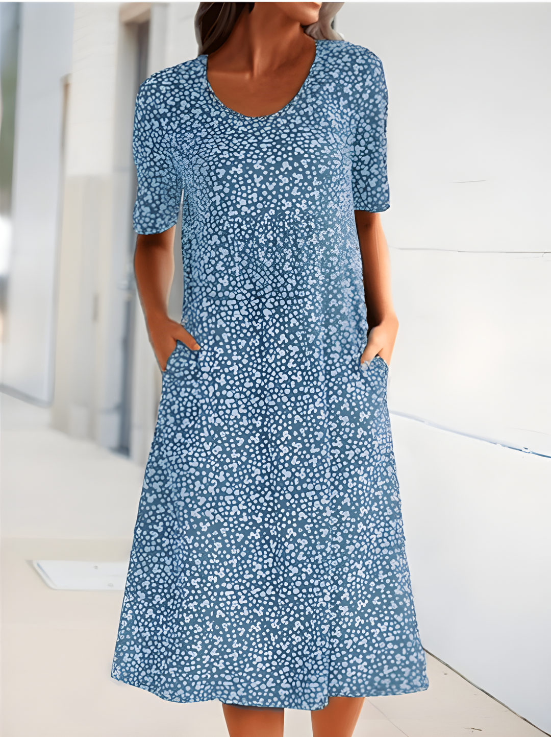 Vibrant floral print women's midi dress, featuring a comfortable round neck & essential pockets. Great for summer casual wear.
