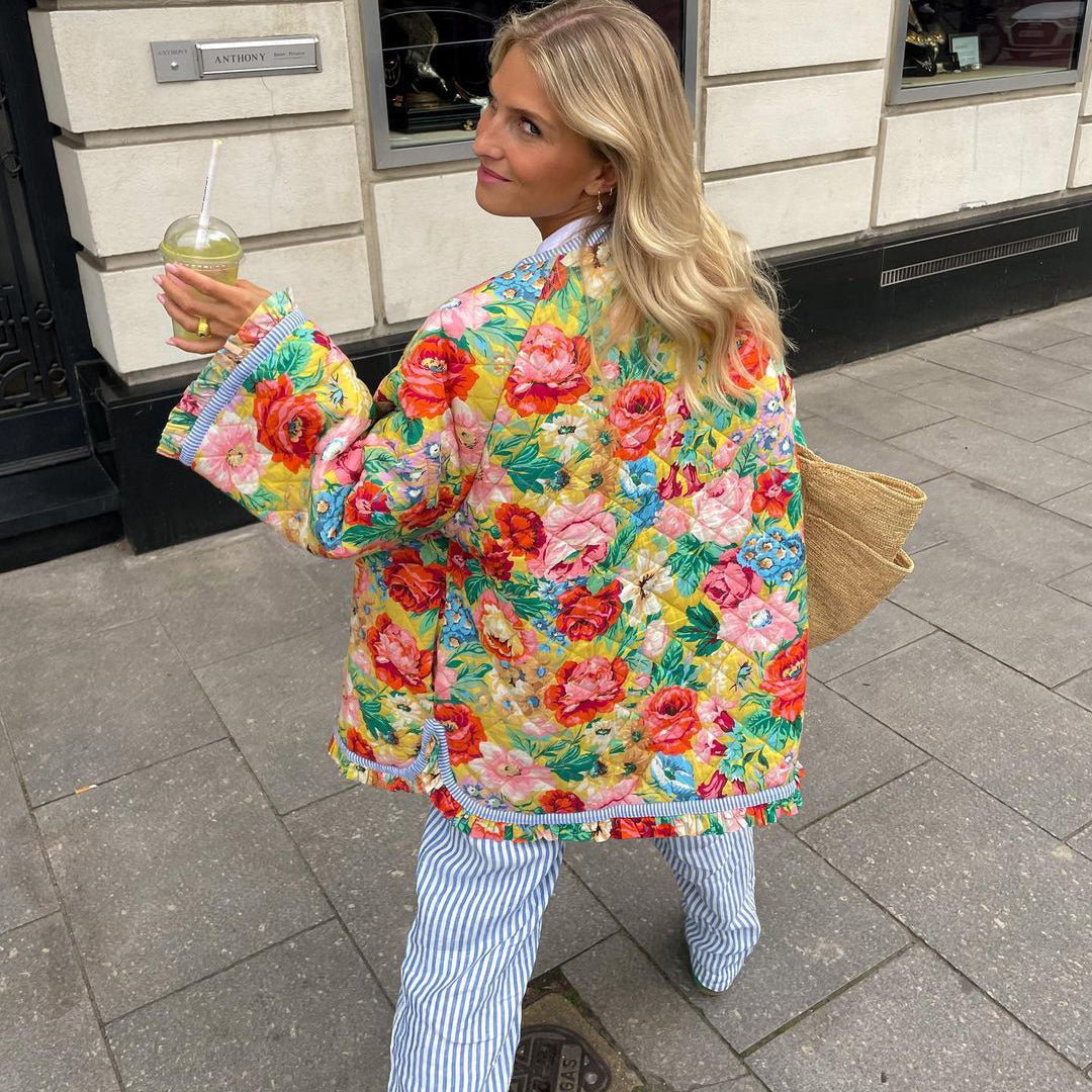 Oversized women's quilted jacket featuring a beautiful vintage-inspired floral pattern, great for casual winter wear.