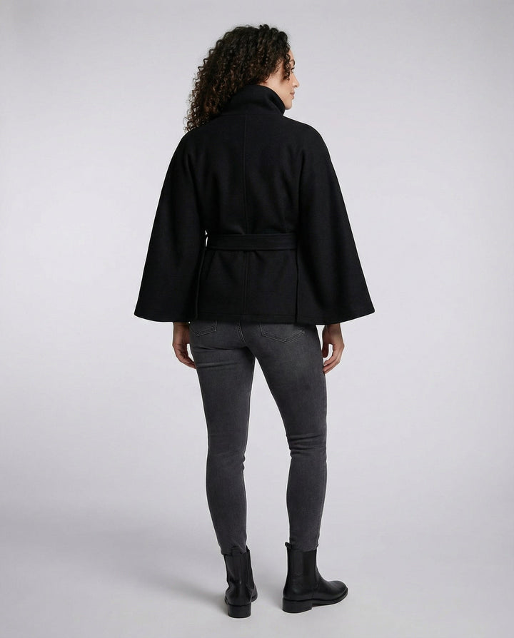 Chic women's fall fashion: a long belted wrap jacket with a distinctive high collar, embodying elegant outerwear.