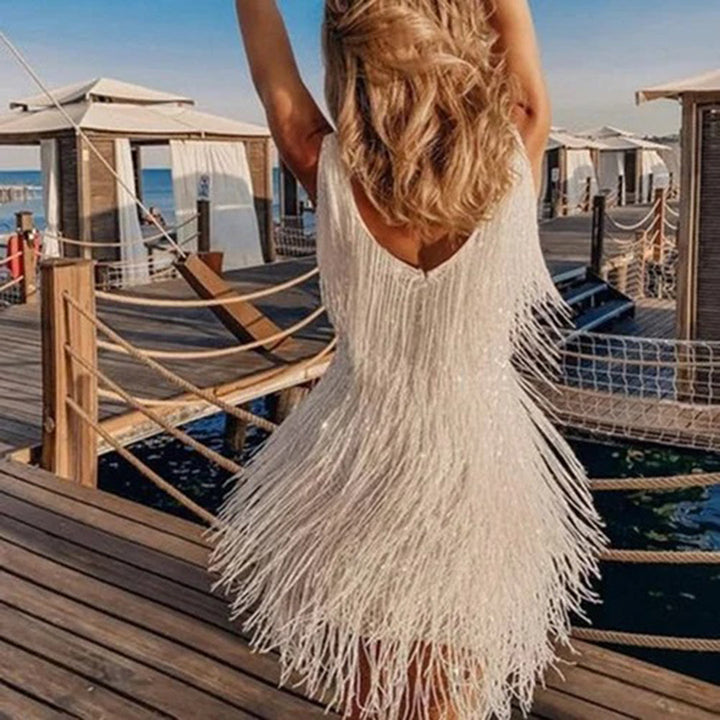 Sophisticated women's chic mini dress with eye-catching tassels, great for any special event.