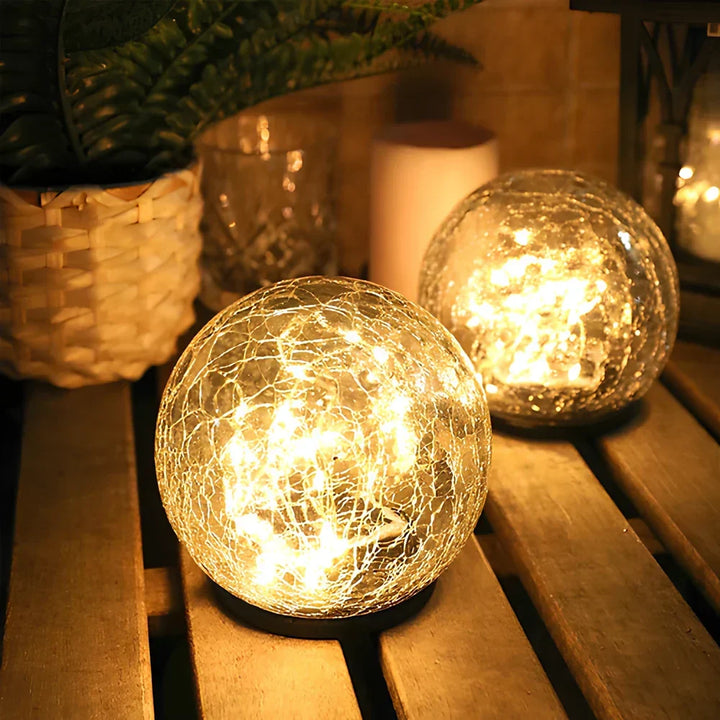 Waterproof solar garden light: crackled glass orb with a warm white LED glow.
