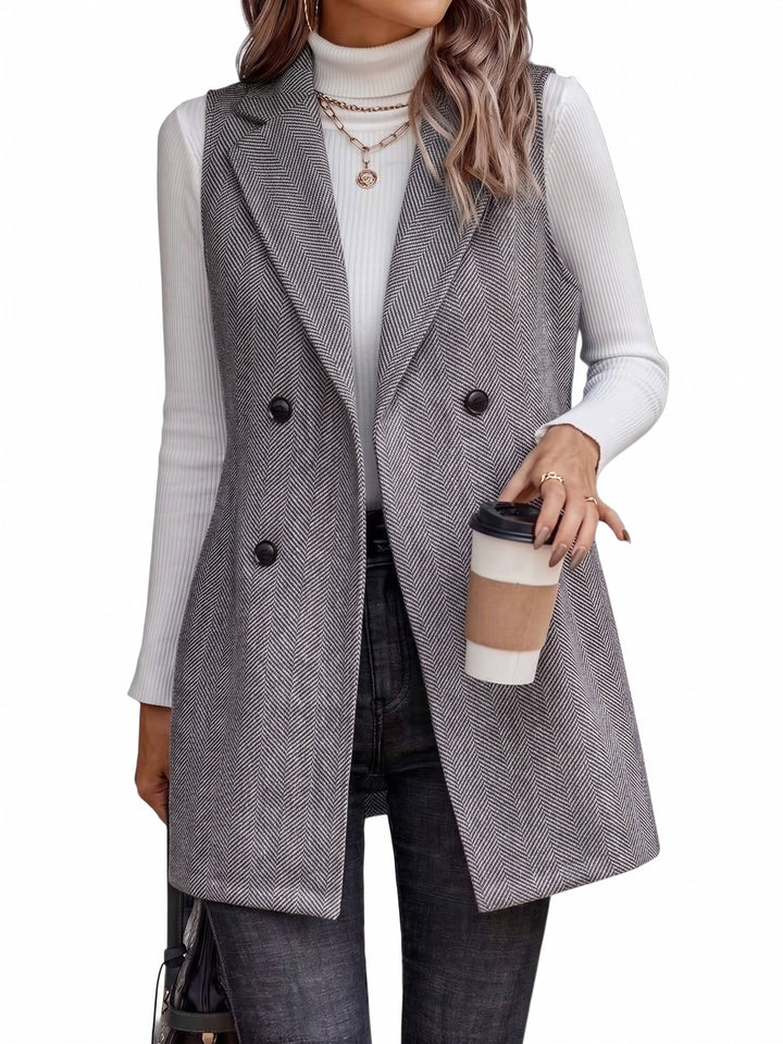 Close-up of women's double breasted vest blazer, showing classic lapel and button details.