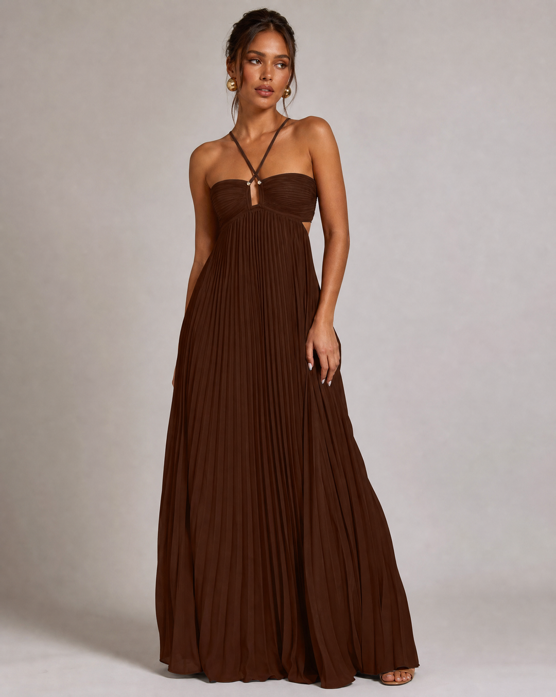 Chic flowy pleated maxi dress with a halter neck & open back, ideal for wedding guests & parties.