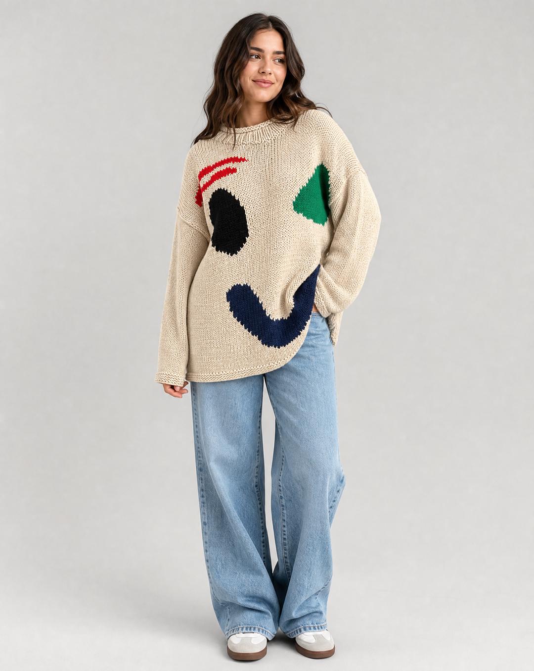 Fashionable women's oversized smiley face cardigan. A cozy, trendy layering sweater for everyday fall style.