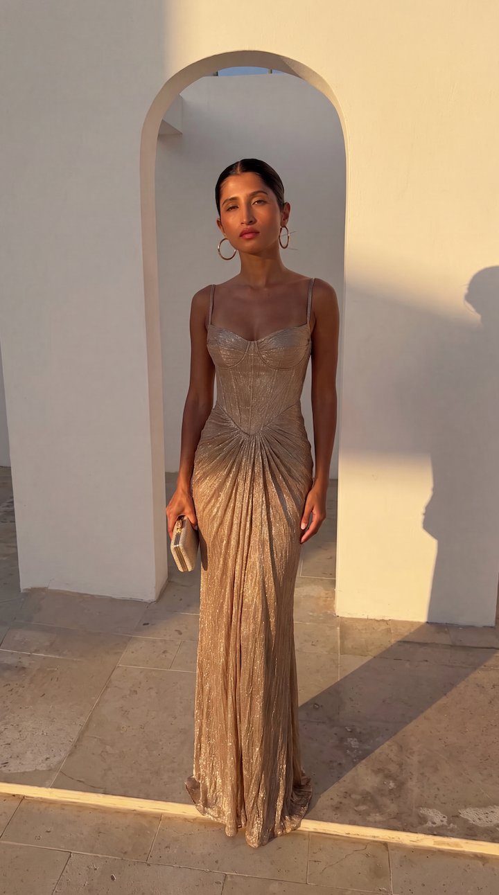 Sleeveless shimmer maxi dress for women, featuring a ruched bodice & elegant draped skirt for special occasions.