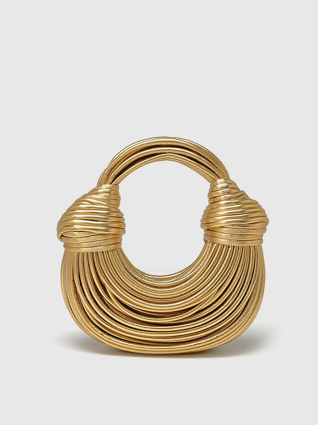 Golden twisted hoop handbag for women. Elegant polyurethane statement purse with unique design.