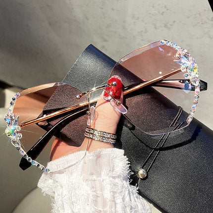 Glamorous women's rimless rhinestone sunglasses with a gold frame, perfect fashion accessory.