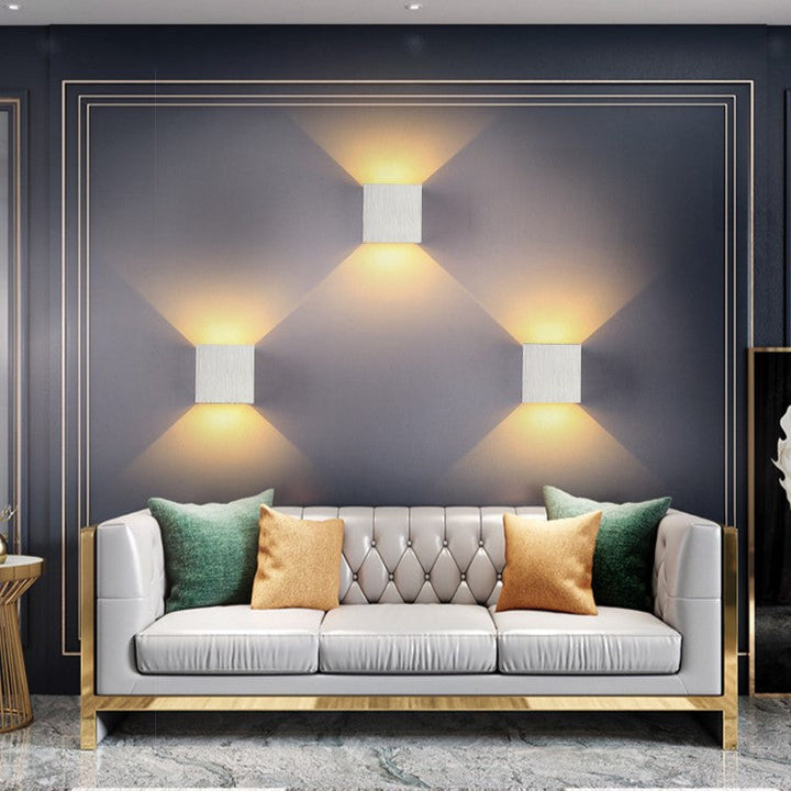 Sleek aluminum cube LED wall sconce. Provides up/down accent lighting for modern home decor.