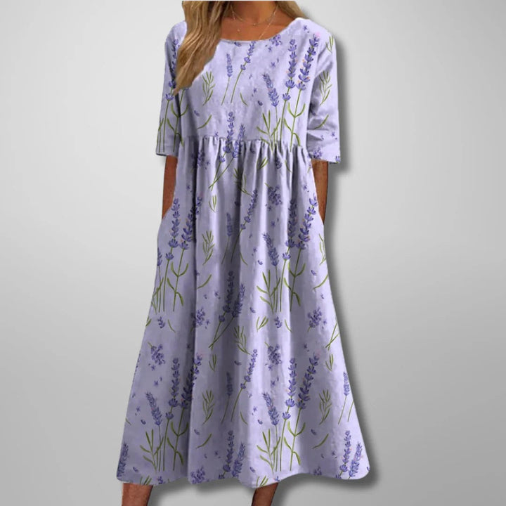 Flowing women's floral midi dress. Relaxed fit, perfect for elegant spring or casual summer occasions. Available in navy.