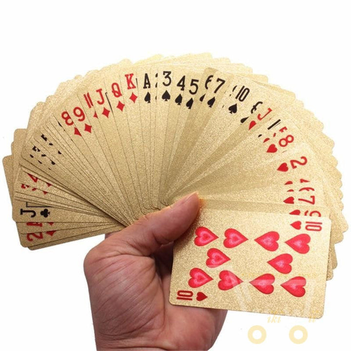 Open wooden box revealing a full deck of gleaming 24K gold-plated playing cards, a luxury collectible.