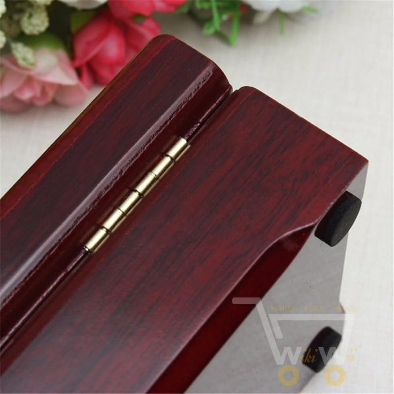 Premium 24K gold-plated playing card deck, durable and shiny, stored in a luxurious wooden box for display.