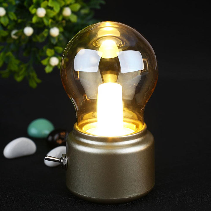 Elegant retro LED table lamp with USB charging. Emits a cozy warm glow, great for reading & decor.