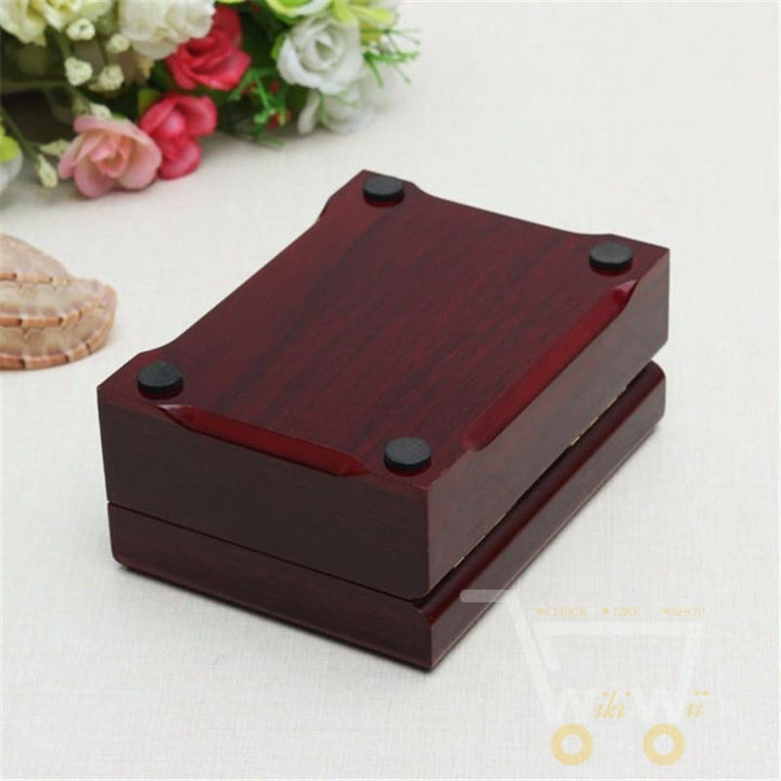 Collectible 24K gold-plated playing cards set with unique design, housed in a sophisticated wooden box.