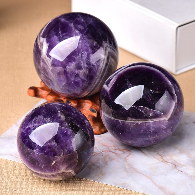 Smooth amethyst crystal sphere, an elegant accent for modern home decor & spiritual spaces.