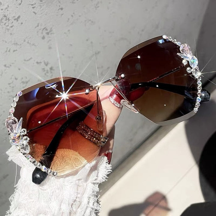 Fashionable women's rimless rhinestone sunglasses, gold frame, offering glamorous UV protection.