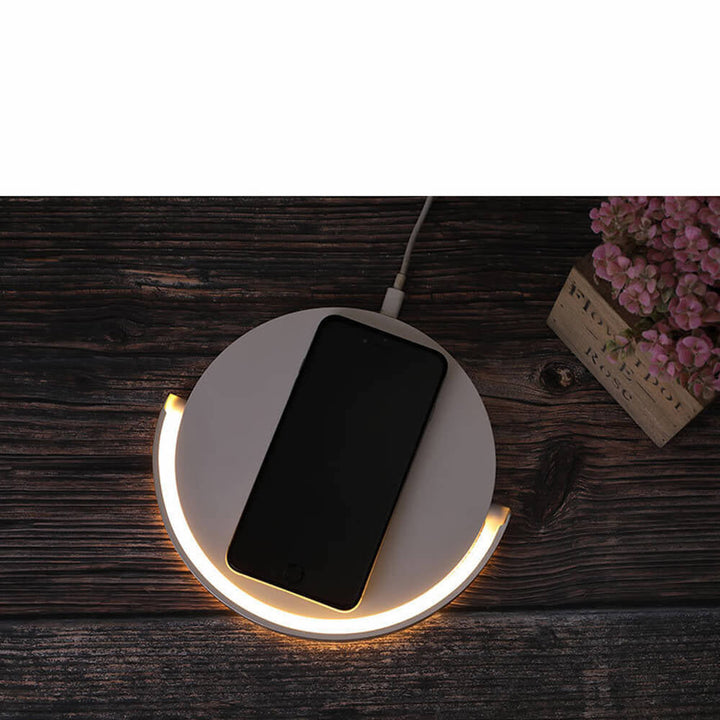 Smart AuraGlow desktop organizer with fast wireless phone charging dock and integrated dimmable LED bedside lamp.