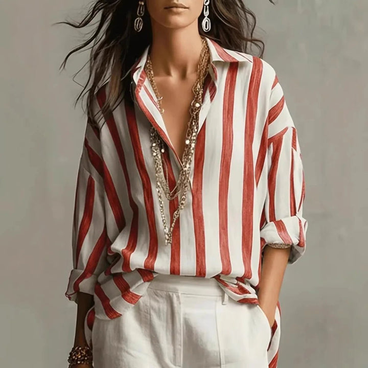 Elegant women's blouse featuring a vertical stripe pattern, stylish open collar, and long sleeves. Chic smart casual top.