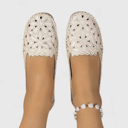 Textured perforated women's slip-on loafers, breathable for warm weather comfort.