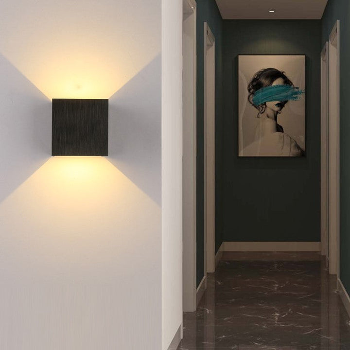 Stylish LED wall sconce with up/down light. Perfect modern accent lighting for indoor home decor.