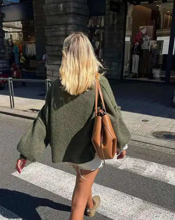 Chic women's oversized sweater with a relaxed, fluffy fit, ideal for cozy winter layering.