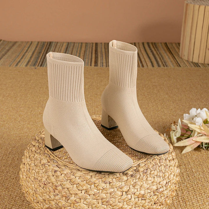 Close-up of elegant women's ankle boots, sleek design & comfortable fit for stylish steps & fall outfits.