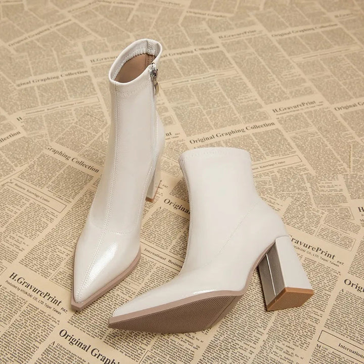 Stylish women's ankle boots with a modern block heel, great for fall fashion trends.