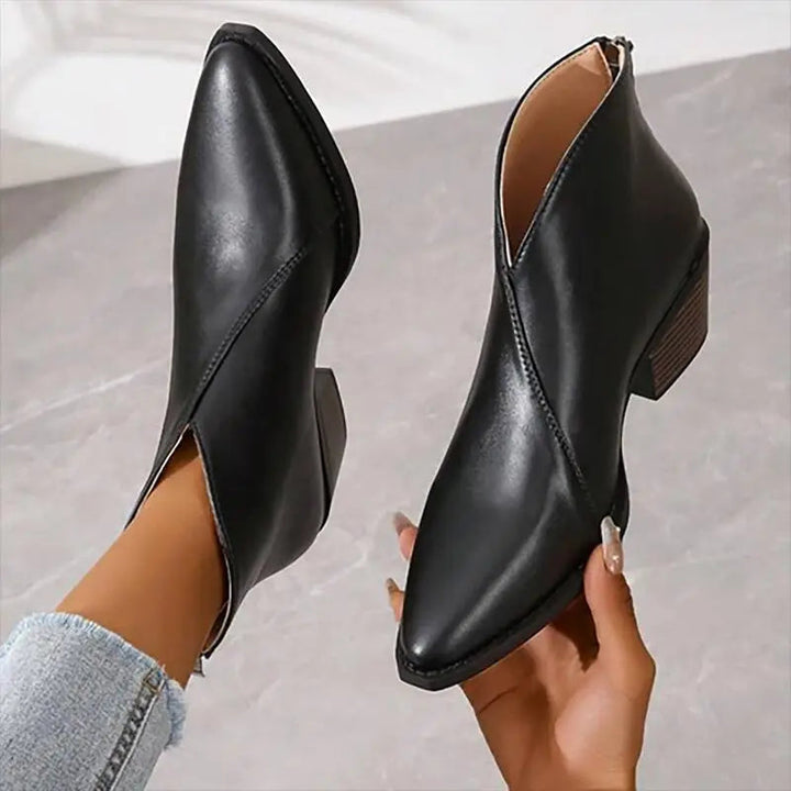 Women's black ankle boots with a trendy platform heel and pointed toe, perfect for elevated fashion looks.