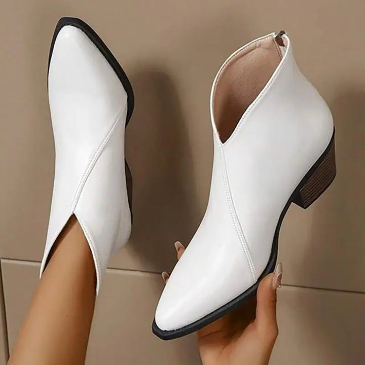 Stylish women's platform ankle boots featuring a sleek pointed toe & comfortable chunky heel for everyday wear.