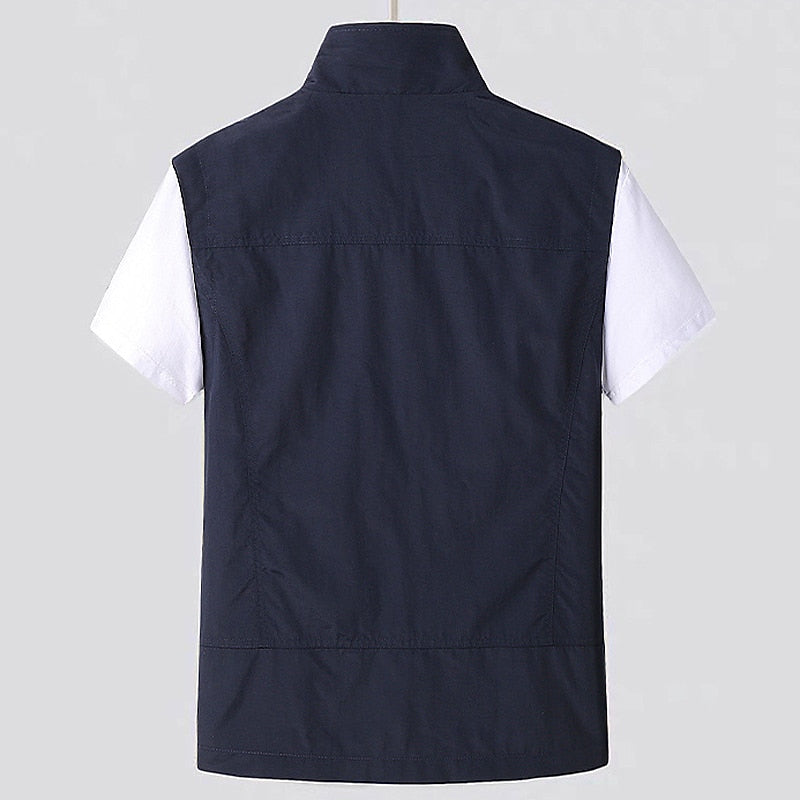 Close-up of men's water-resistant utility vest showing stand collar, sturdy zipper, and durable fabric for layering.