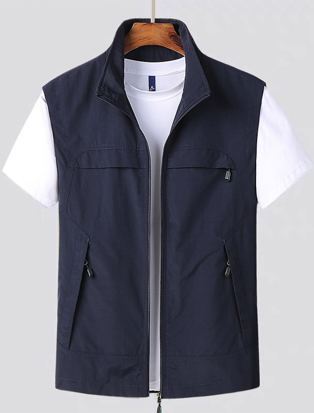 Men's water-resistant utility vest with stand collar, front zip closure, and multiple zip pockets for outdoor activities.