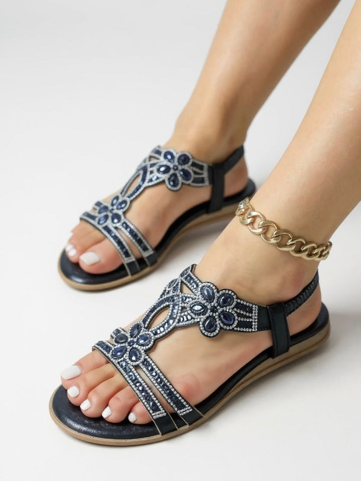 Women's sparkling embellished sandals with cushioned comfort for stylish summer wear.