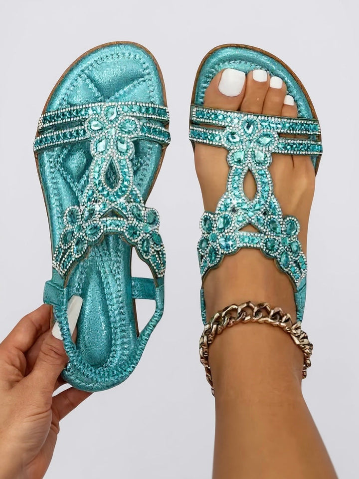 Women's sandals with intricate sparkling embellishments and a supportive, cushioned footbed.