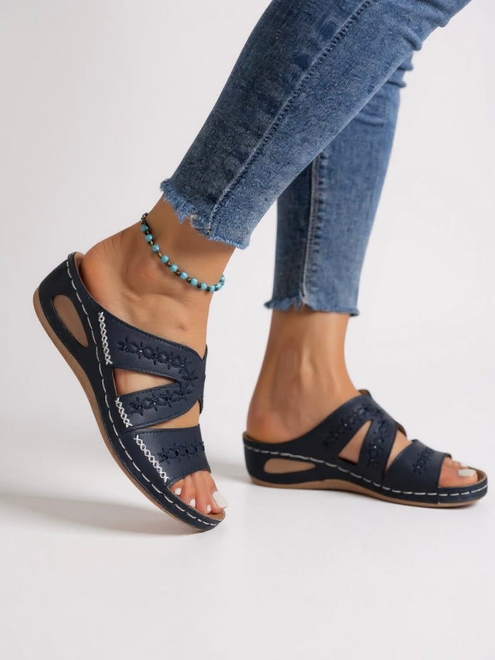 Women's summer sandals, embroidered slip-on design offers comfort & stylish warm weather wear.