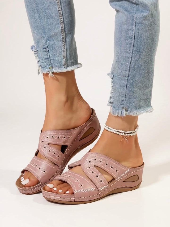 Stylish slip-on sandals for women, detailed with elegant embroidery, ideal summer footwear.
