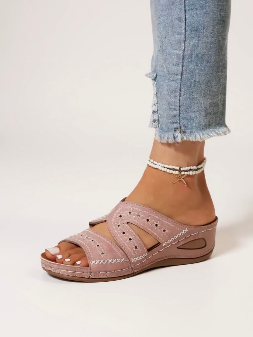 Elegant women's slide sandals with embroidery, comfortable slip-on footwear for any occasion.