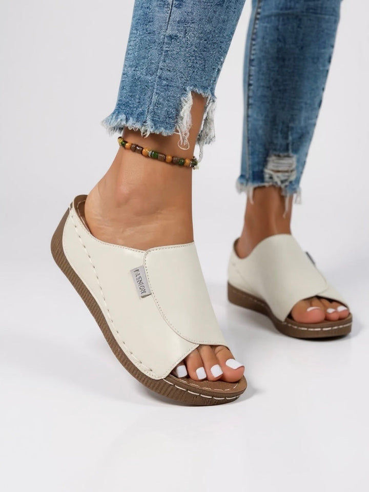 Stylish women's platform slides; comfortable, minimalist design for everyday summer wear.
