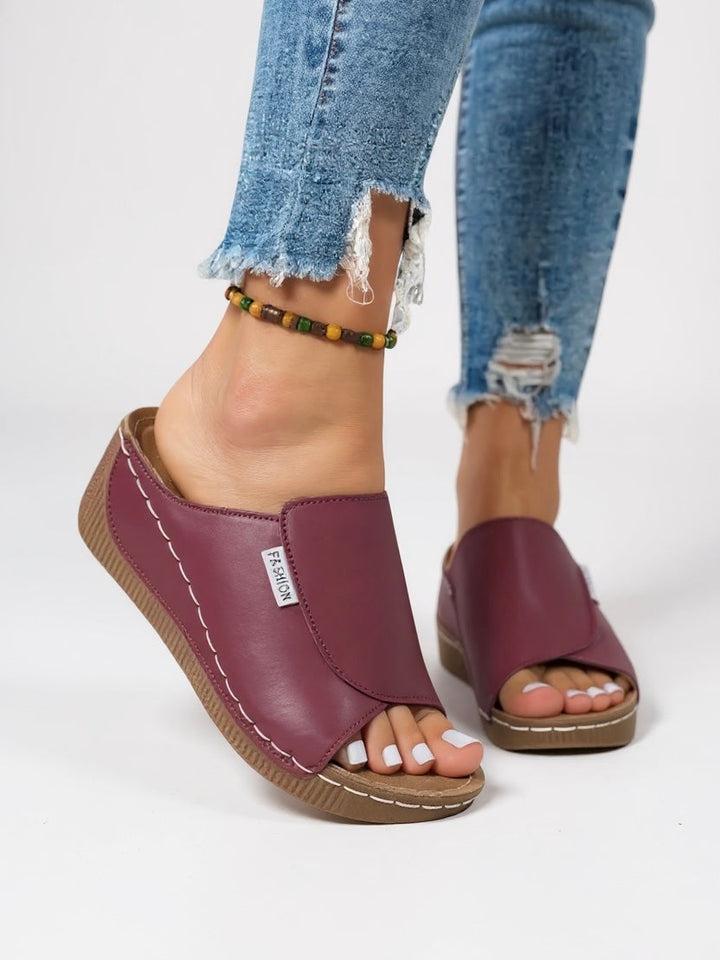 Lightweight women's platform slides; casual slip-on sandals offering elevated comfort.