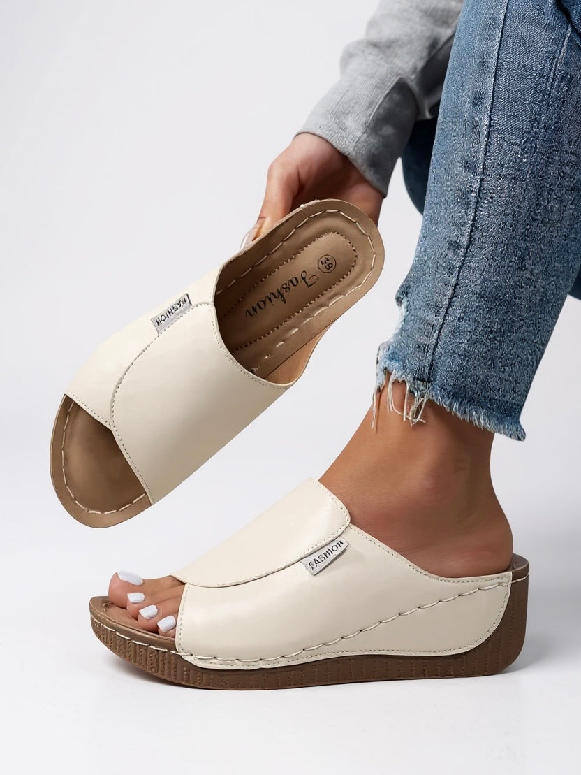 Elevated comfort women's platform slides; lightweight, slip-on sandals for casual fashion.