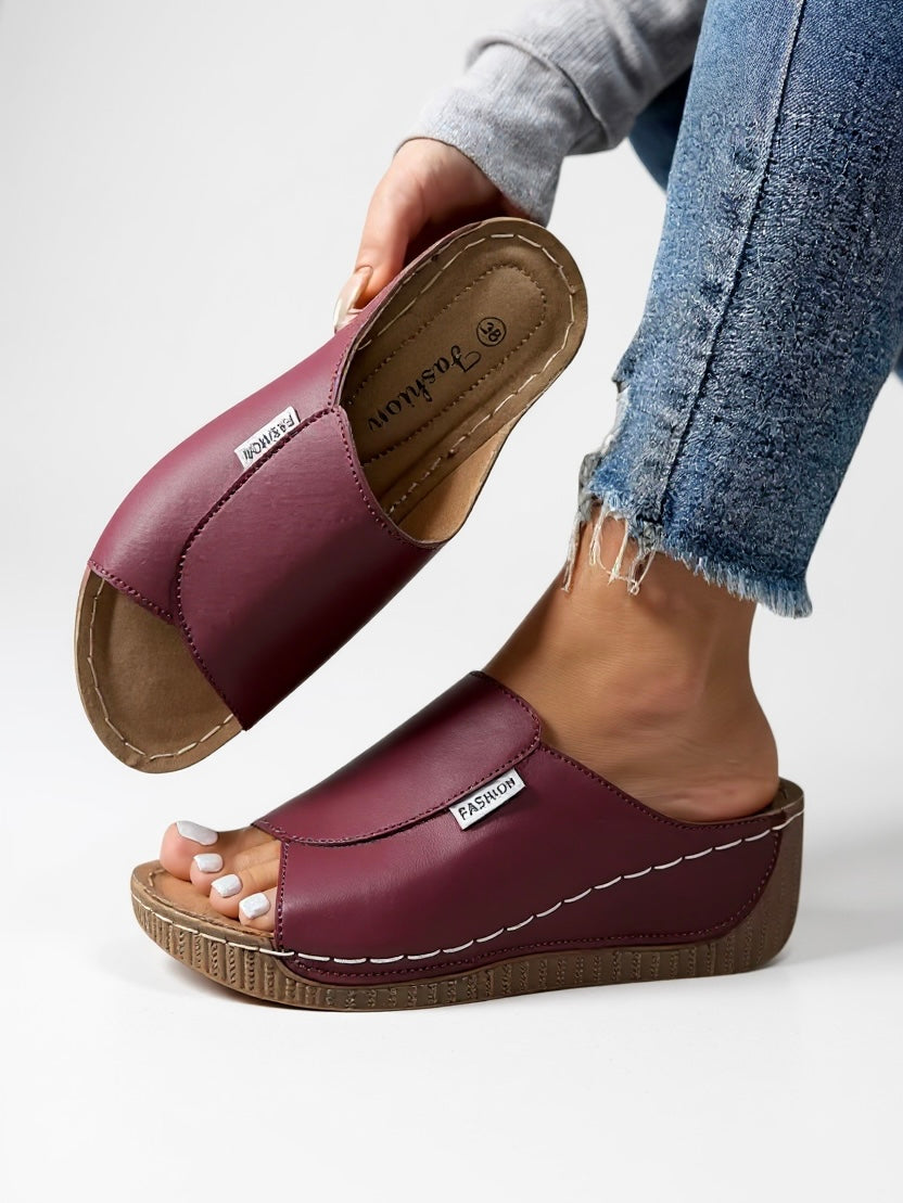 Comfortable women's platform slides; minimalist, stylish flats for effortless summer fashion.