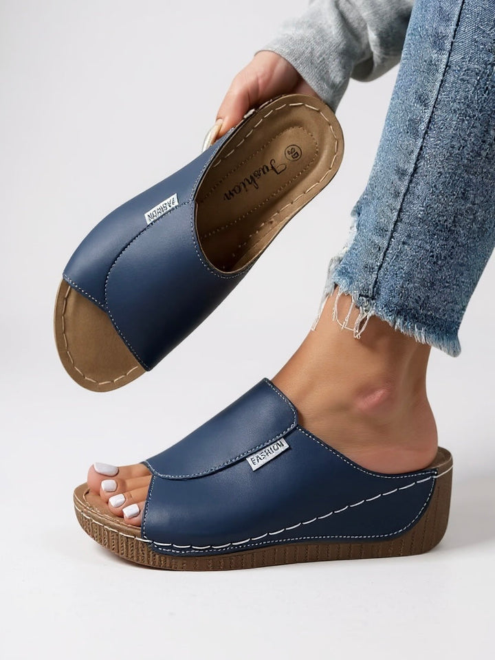 Breathable women's platform slides; lightweight slip-on sandals, ideal for warm weather comfort.