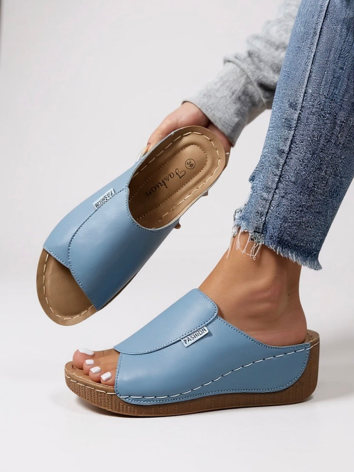 Minimalist women's platform slides; stylish, comfortable, & lightweight for summer fashion.